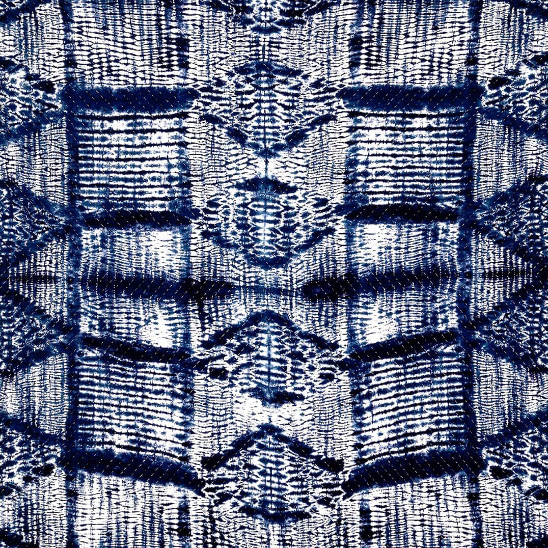 Indigo Shyburi quilt by Bombaybirds, hand-crafted living textile with traditional shibori dyeing, showcasing intricate blue patterns.