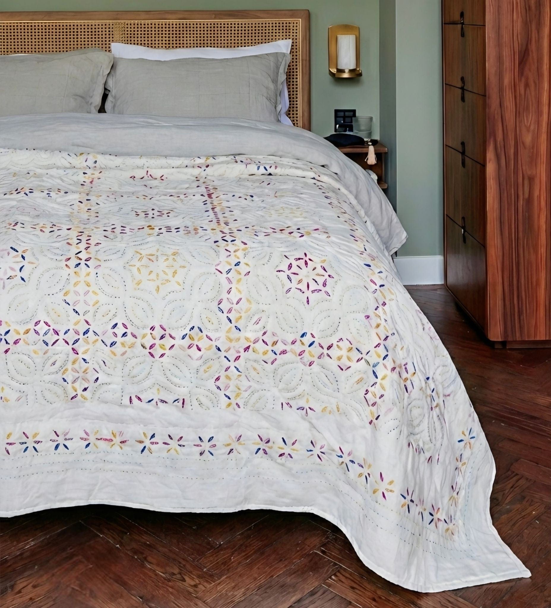 Colorful Kutch rainbow quilt from Bombaybirds, hand-stitched living room blanket with vibrant, intricate embroidery.
