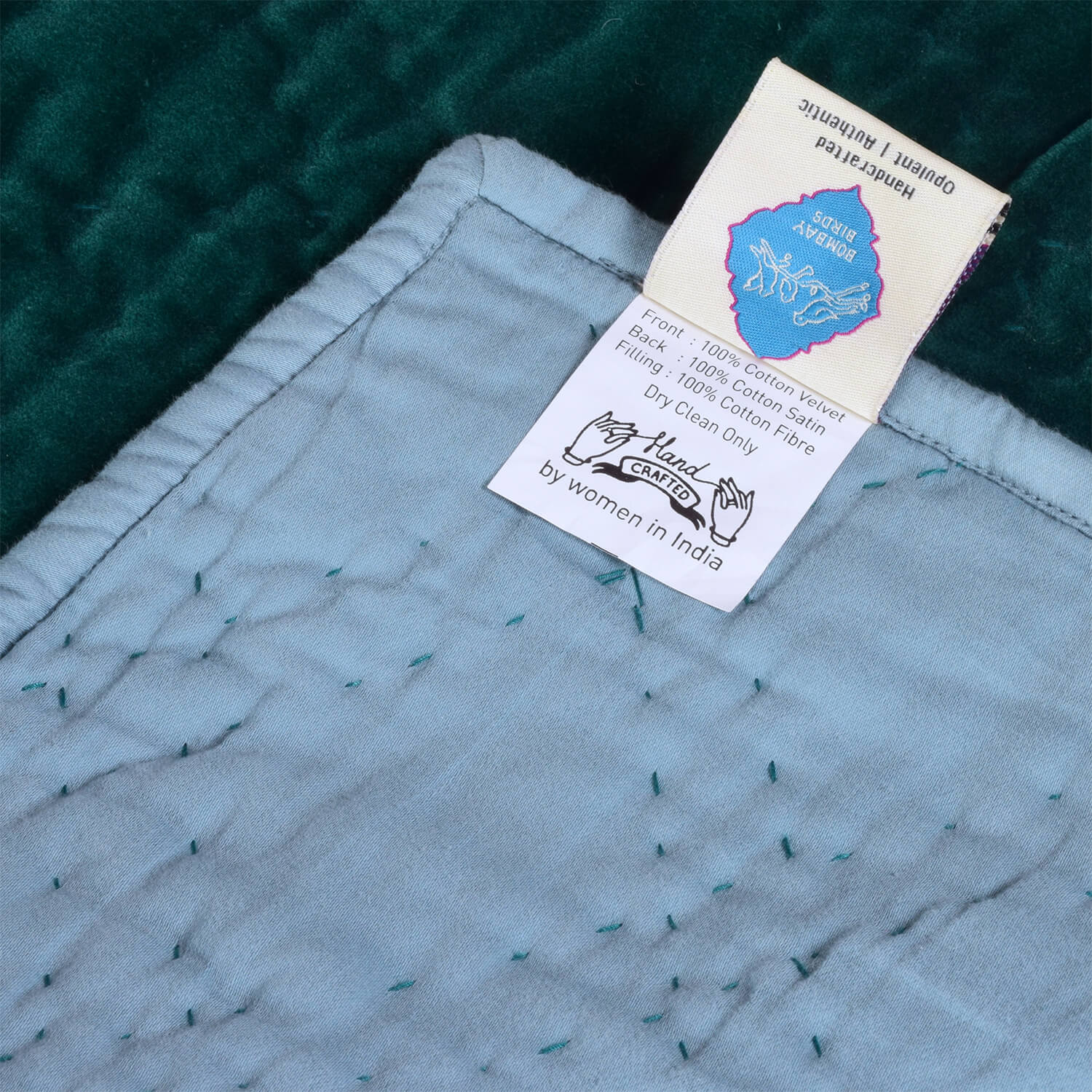 Emerald celeste velvet reversible quilt for living room, handcrafted by Bombaybirds with sustainable craftsmanship.
