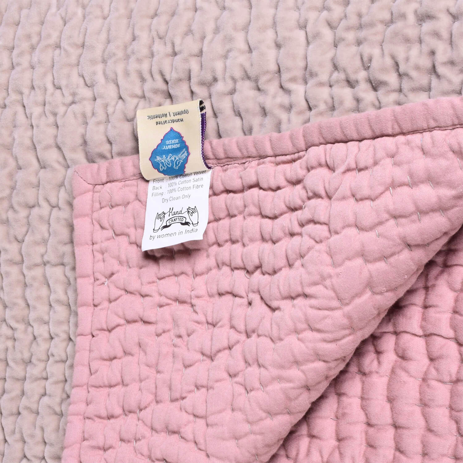 Reversible blush rose velvet quilt for living rooms, handcrafted by Bombaybirds, featuring soft cotton fabric and elegant design.