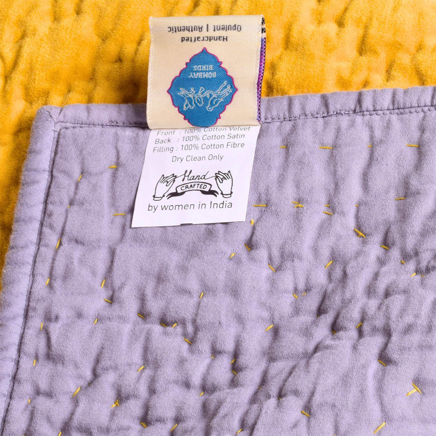 Reversible lilac velvet quilt by Bombaybirds, showcasing soft, plush fabric with intricate stitching and elegant design details.