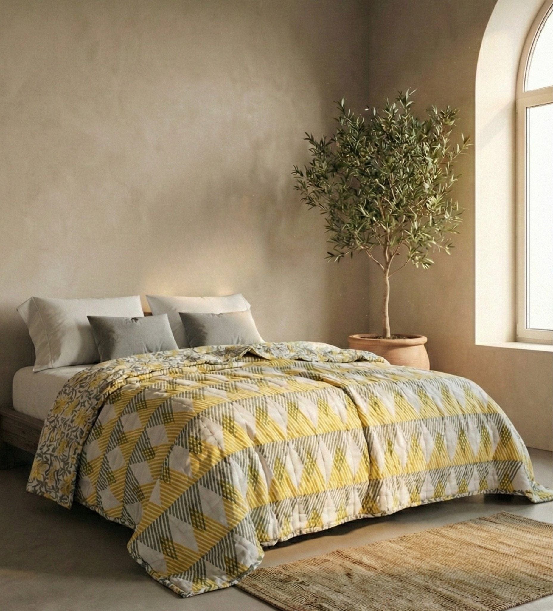 Reversible Sunnie chintz quilt by Bombaybirds featuring yellow and gray floral patterns, perfect for living room decor.