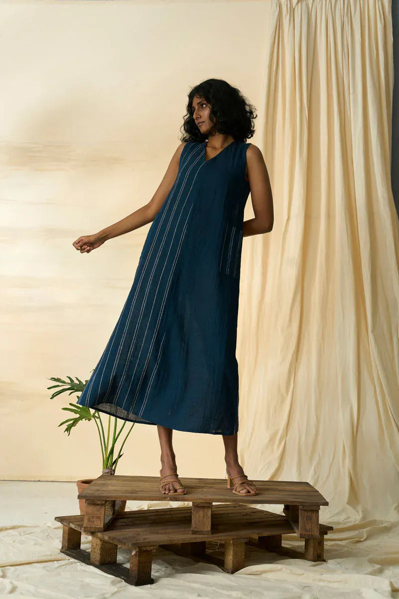 Cobalt sleeveless maxi dress by Alternative, flowing fabric with a fitted bodice and ankle-length skirt, displayed on a hanger.