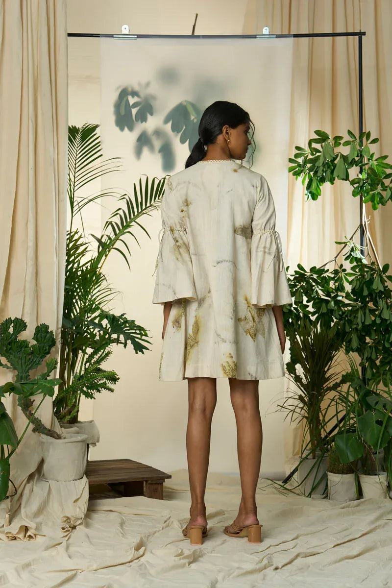Alternative live leafy smocked maxi dress with a flowing silhouette and leafy print, styled for a bohemian look.