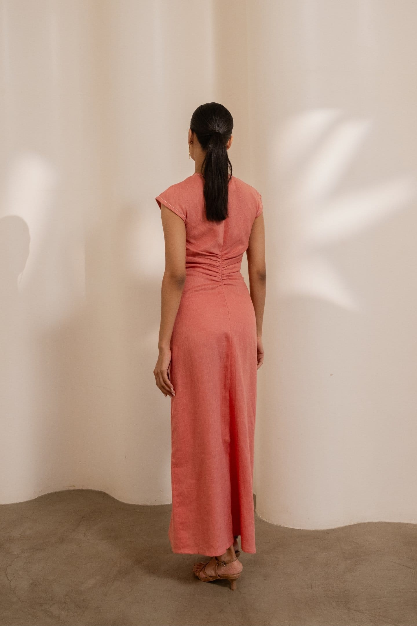 Dawn orange cinched maxi dress by Alternative, featuring a fitted waist and flowing fabric, perfect for casual or dressy occasions.