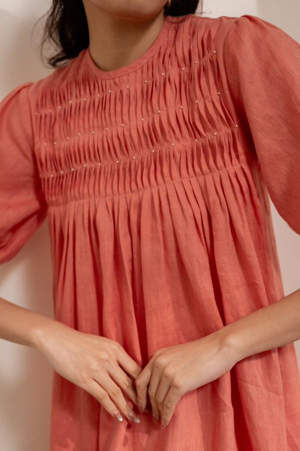 Orange Dawn smocked maxi dress by Alternative, featuring a relaxed fit with smocking details and flowing fabric.