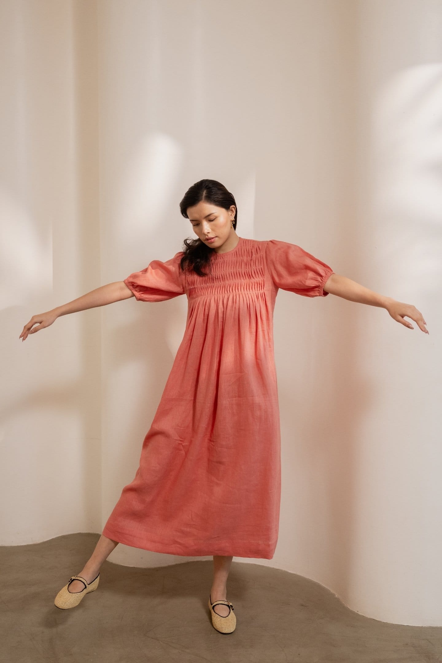 Dawn-orange smocked maxi dress by Alternative, flowy and stylish with a fitted bodice and soft fabric, perfect for casual wear.
