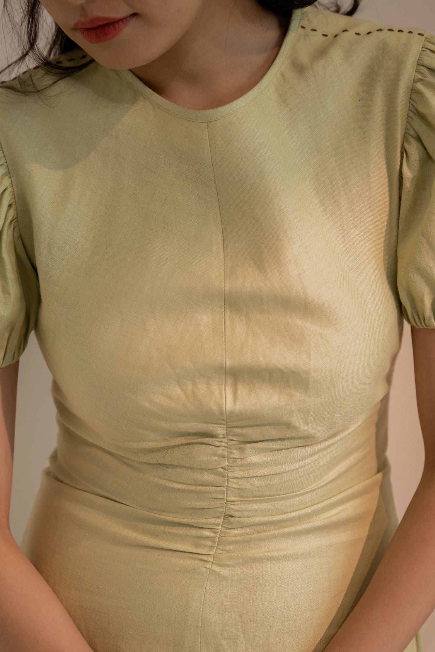 Dew Mint Green Cinched Maxi Dress by Alternative, featuring a fitted waist and flowing fabric, displayed on a hanger.
