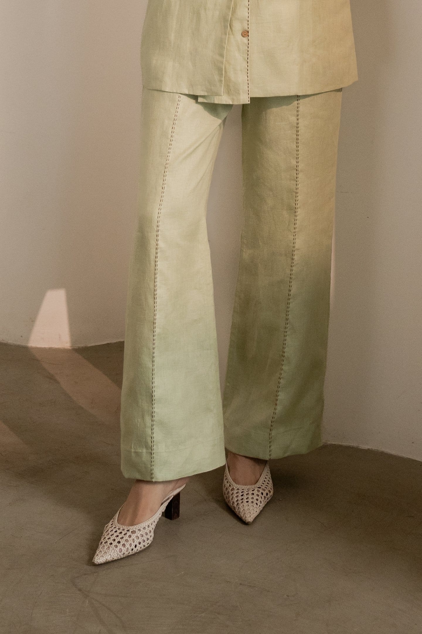 Mint green Dew trousers by Alternative, showing the relaxed fit and fabric texture of these stylish casual pants.