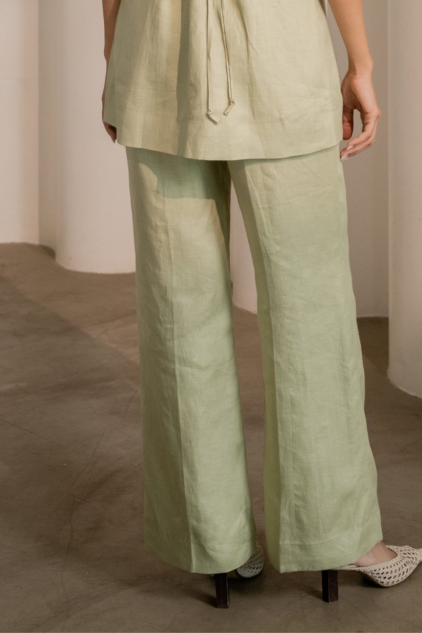 Mint green Alternative Dew trousers laid flat, showcasing their relaxed fit and casual style.