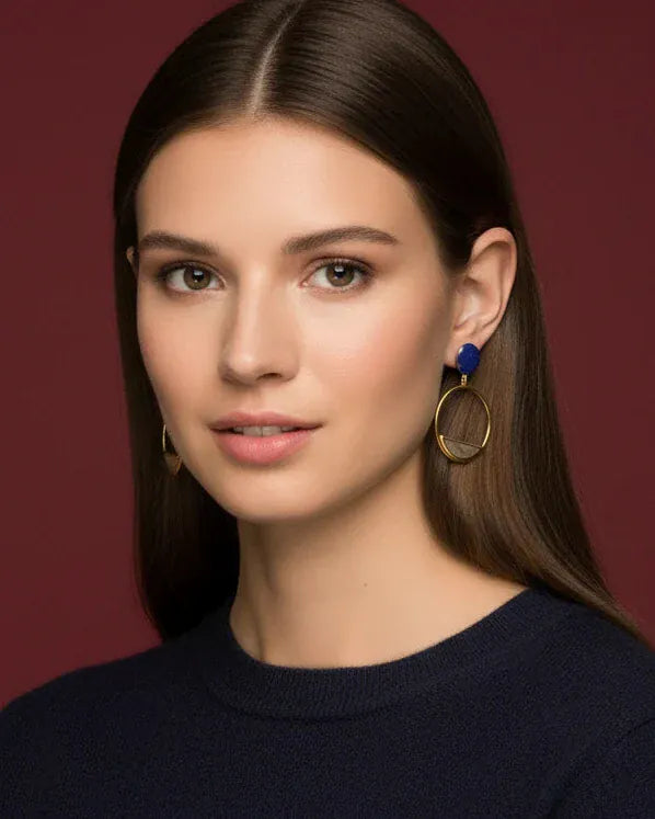 Gold-toned Kaya earrings by Bombaybirds featuring intricate design and elegant dangle style with textured details.