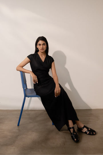 Ebony black cinched maxi dress by Alternative featuring a fitted waist and flowing silhouette, perfect for elegant occasions.