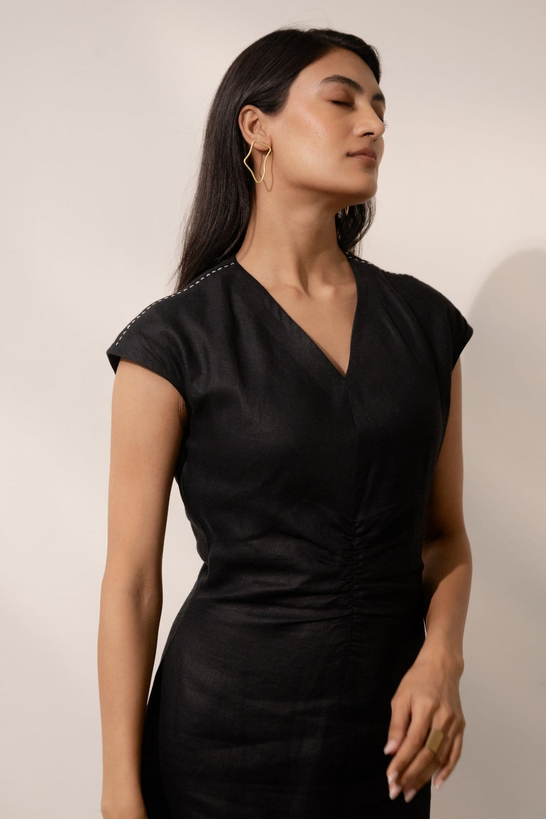 Ebony black cinched maxi dress by Alternative featuring a fitted waist and flowing silhouette, perfect for elegant occasions.