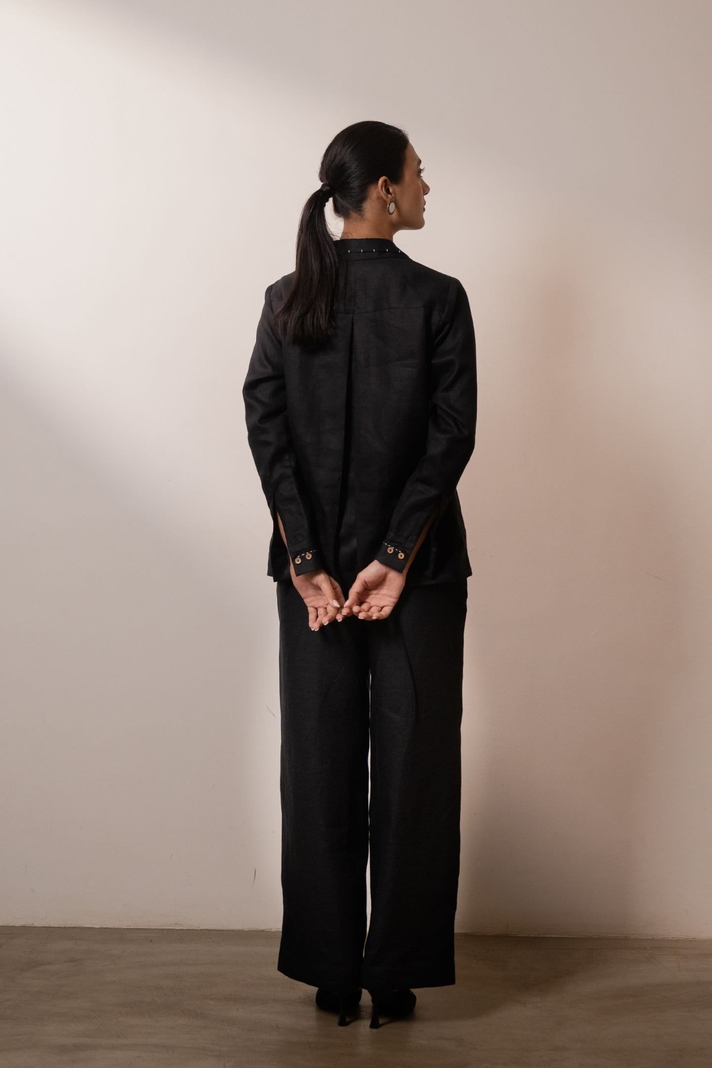 Black ebony pleated trousers by Alternative, featuring hemp fabric and pintuck details, shown on a model.