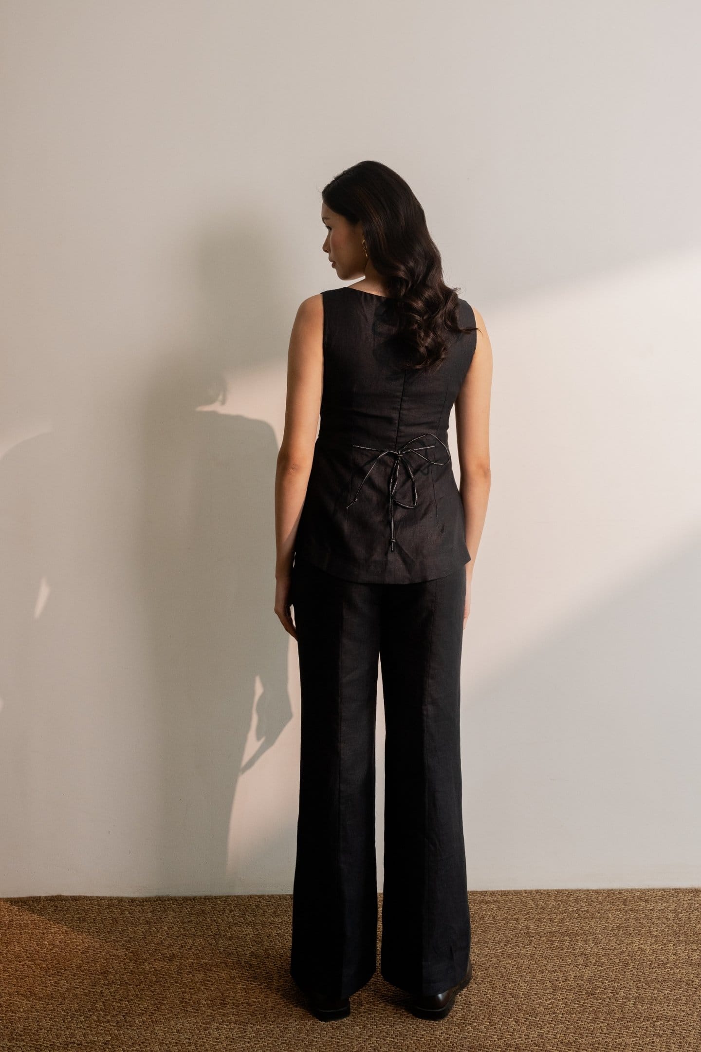 Ebony black trousers from Alternative featuring a sleek fit, made from hemp fabric, styled with a sleeveless top.