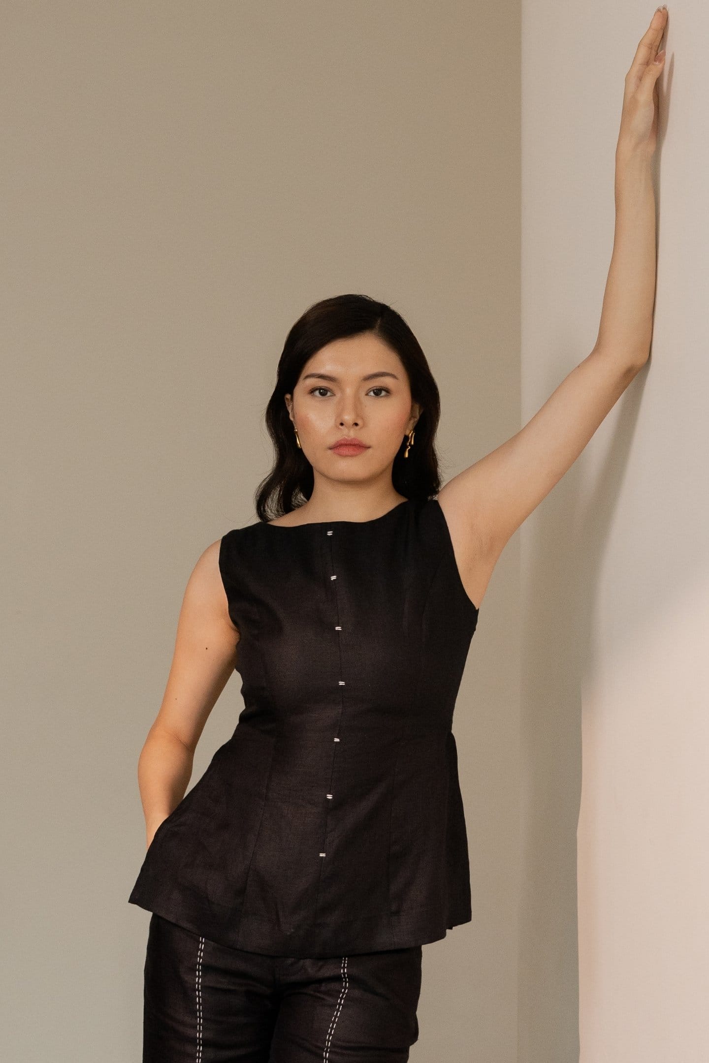 Ebony black sleeveless hemp top by Alternative, featuring a relaxed fit and sleeveless design, displayed on a hanger.