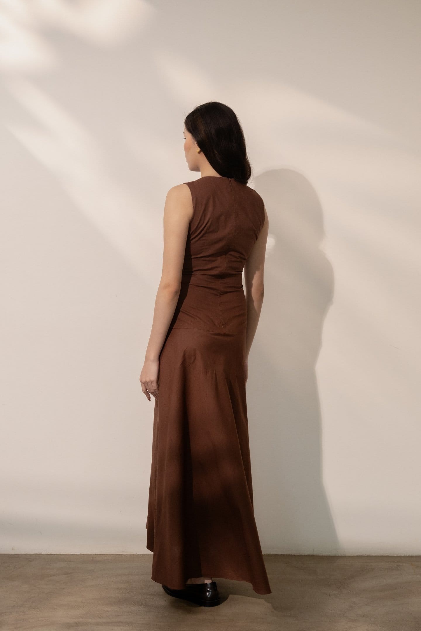Alternative Ether brown maxi dress featuring a flowing fabric, sleeveless design, and a relaxed, elegant fit.