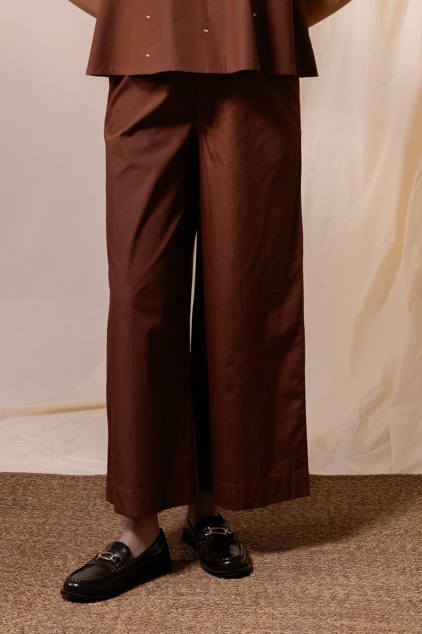 Brown Ether flared trousers by Alternative, featuring wide-leg design and stylish fit, displayed on a plain background.