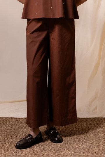 Brown Ether flared trousers by Alternative, featuring wide-leg design and stylish fit, displayed on a plain background.