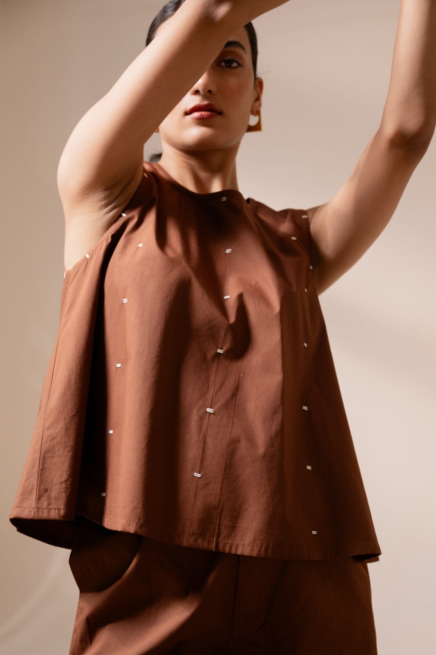 Alternative Ether brown sleeveless top with a relaxed fit, sleeveless design, and casual style.
