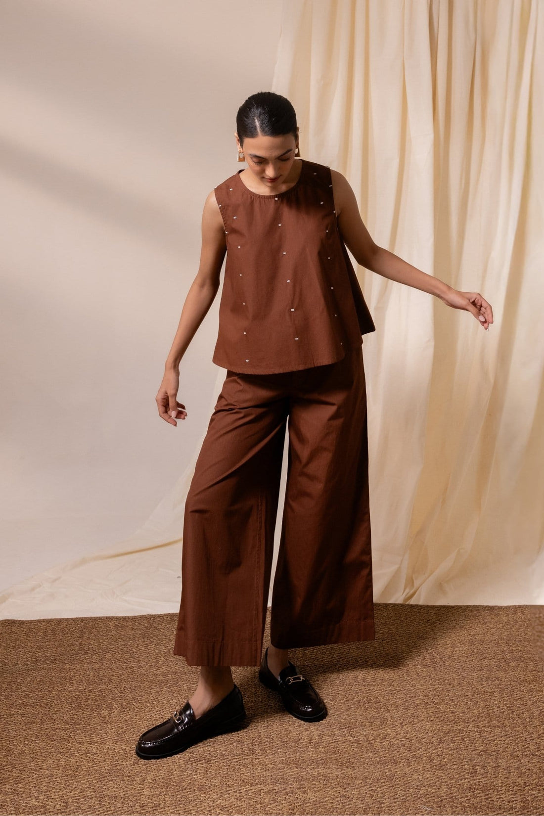 Alternative Ether brown sleeveless top with a relaxed fit, sleeveless design, and casual style.