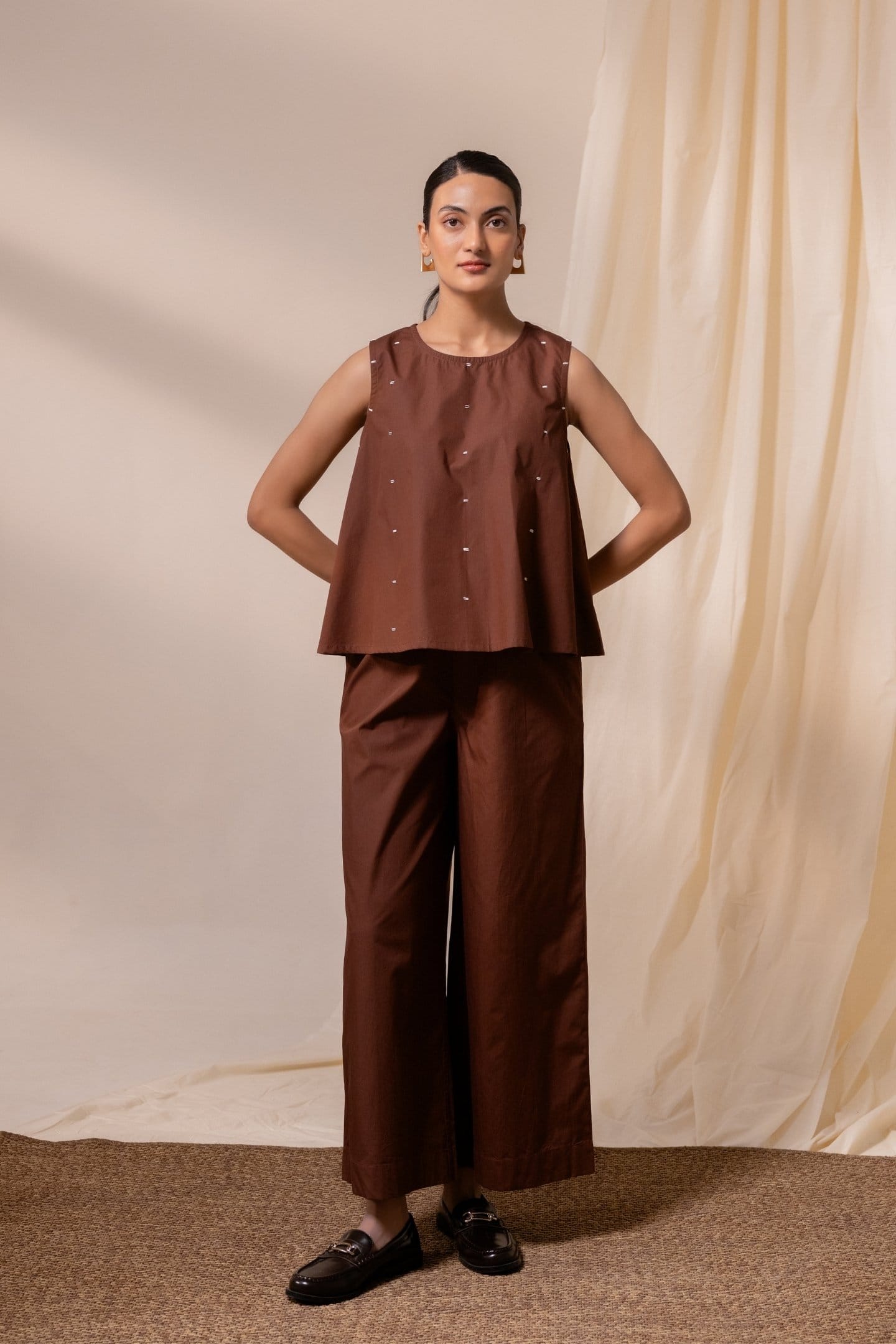 Alternative Ether brown sleeveless top paired with pants, featuring a casual sleeveless design and stylish fit.