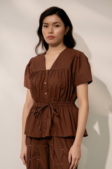Alternative Ether brown tie-up top with long sleeves and V-neck, featuring a stylish front tie detail.