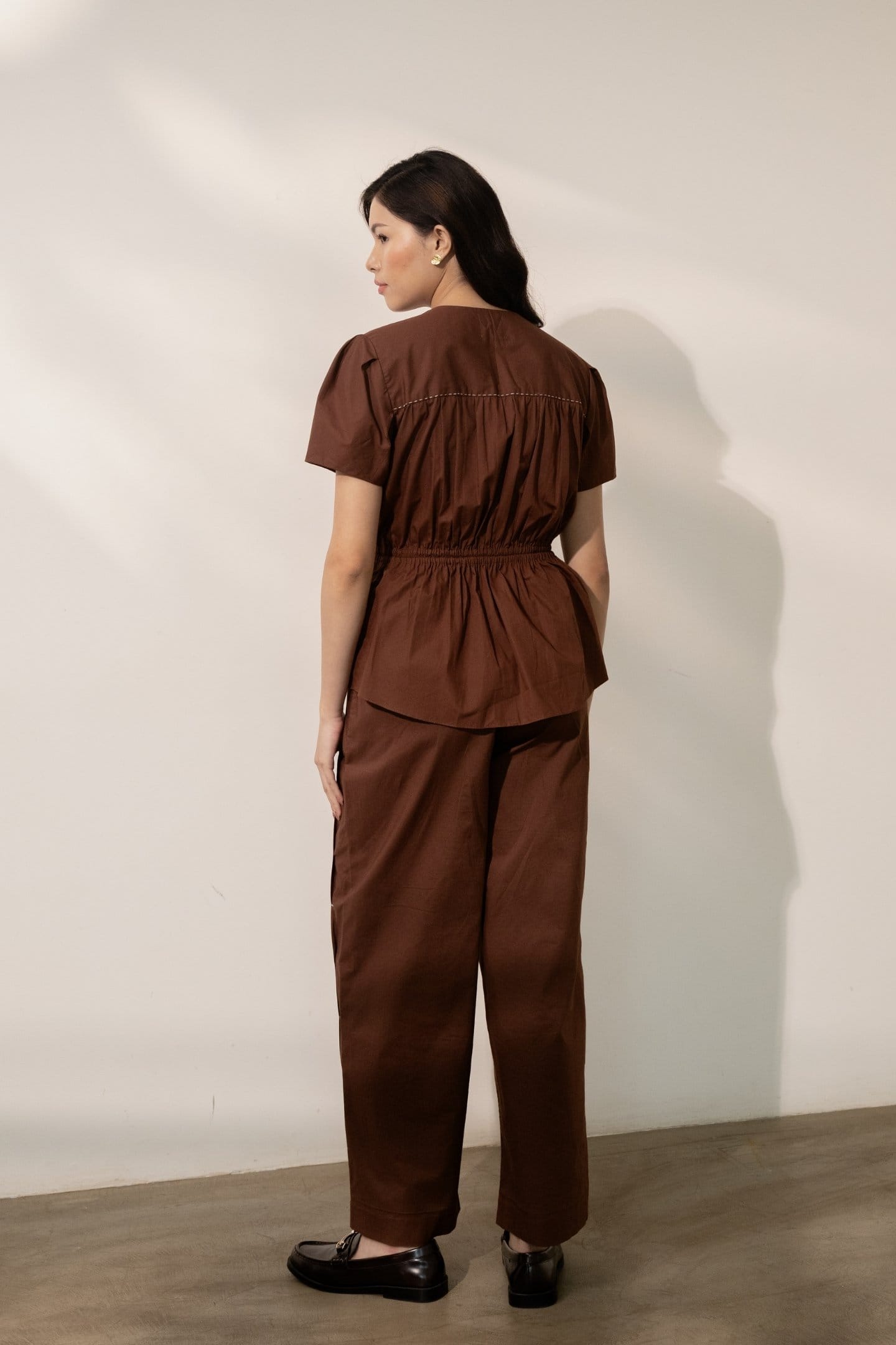 Alternative Ether brown tie-up top paired with matching pants, stylish casual outfit featuring a sleeveless design and tie detail.