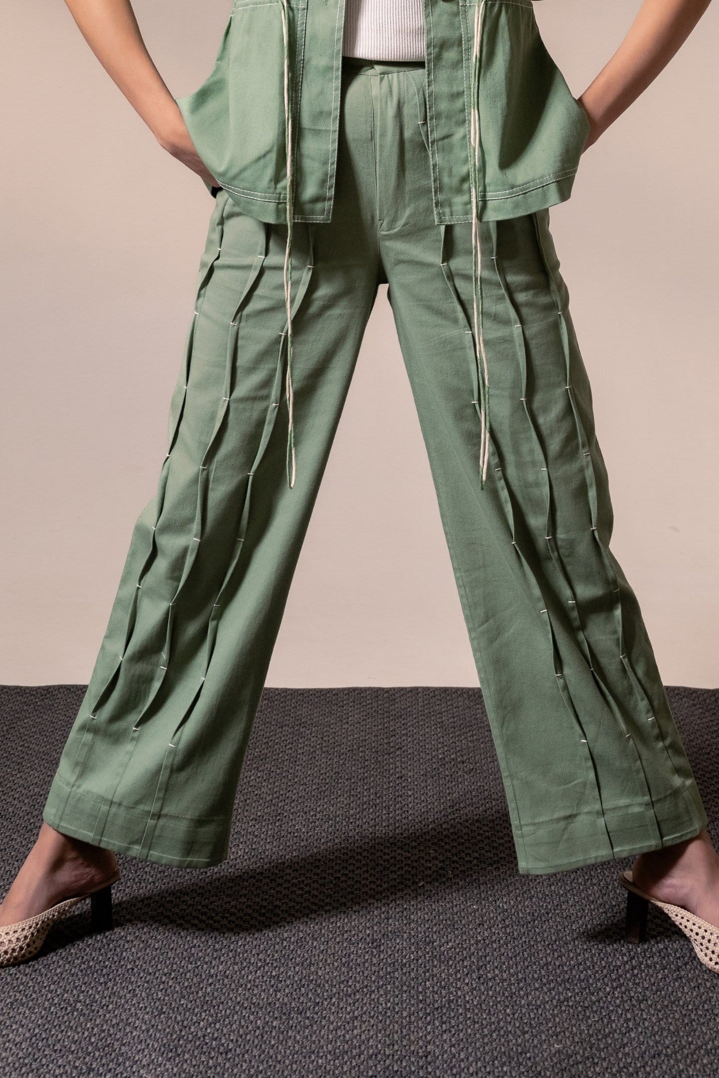 Fern green denim pleated trousers from Alternative, showcasing a relaxed fit with pleats and a stylish, casual design.
