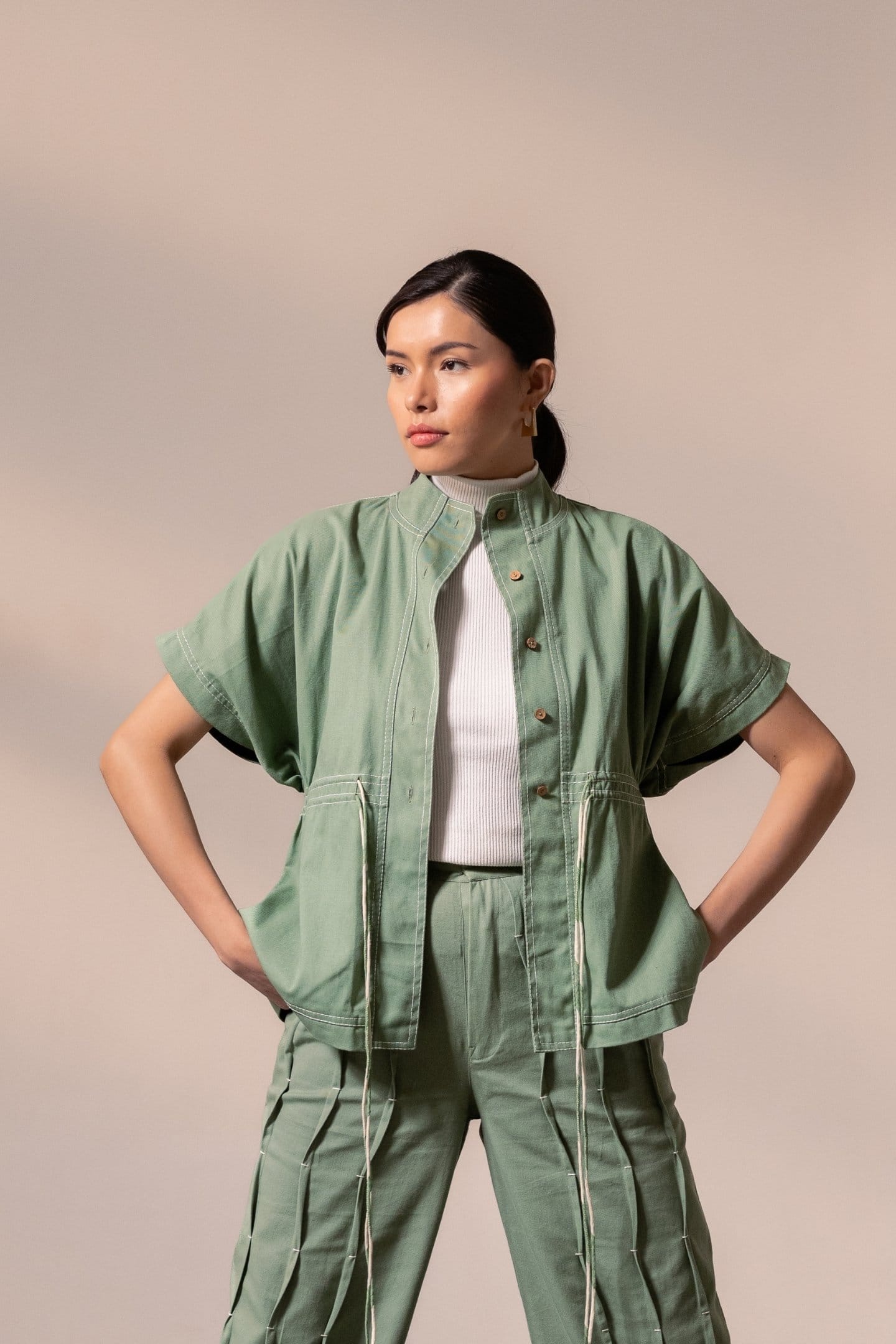 Fern green denim top by Alternative, showing a stylish casual denim blouse with long sleeves and button details.