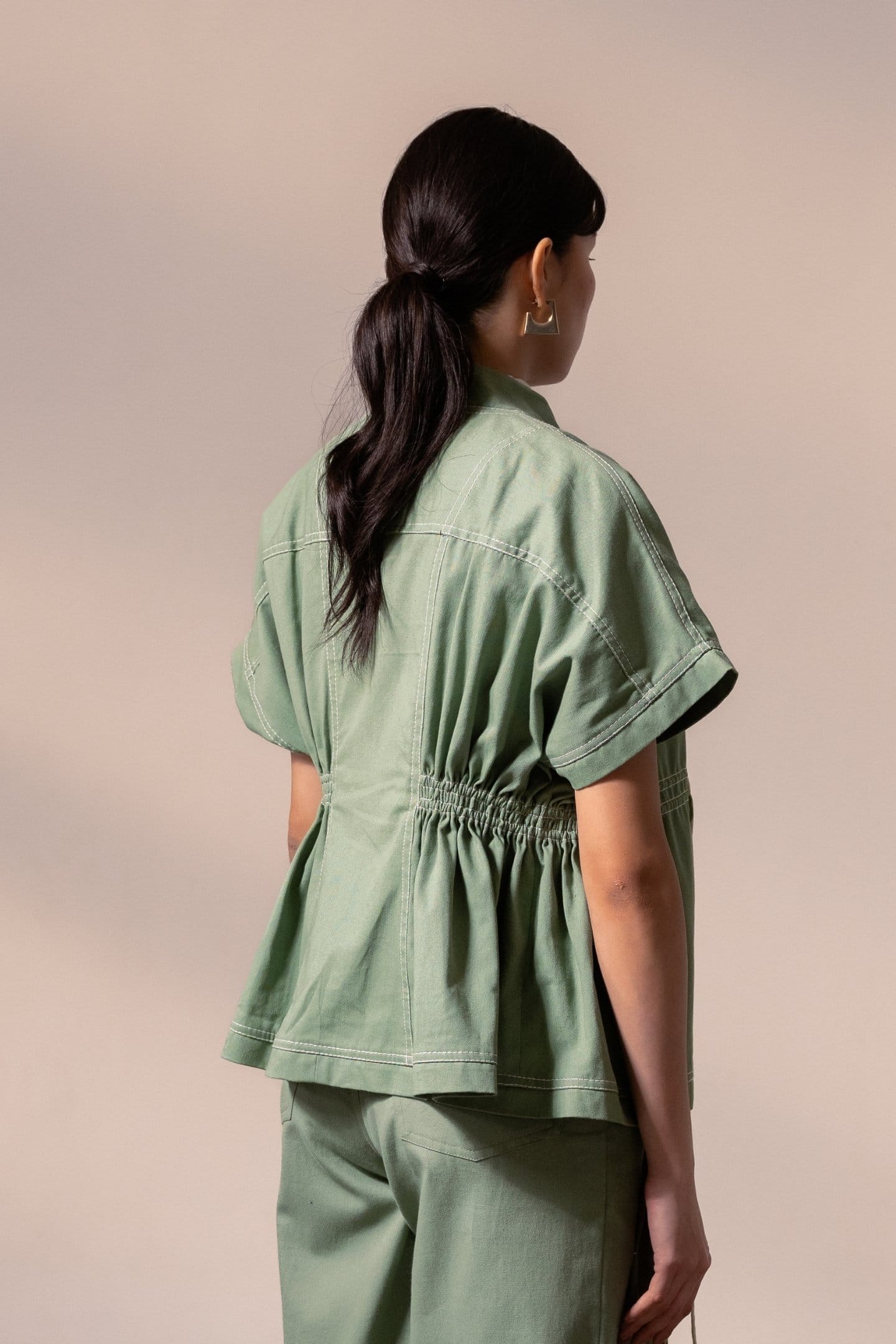 Fern green denim top by Alternative, showcasing a stylish, casual denim blouse with a relaxed fit and button details.