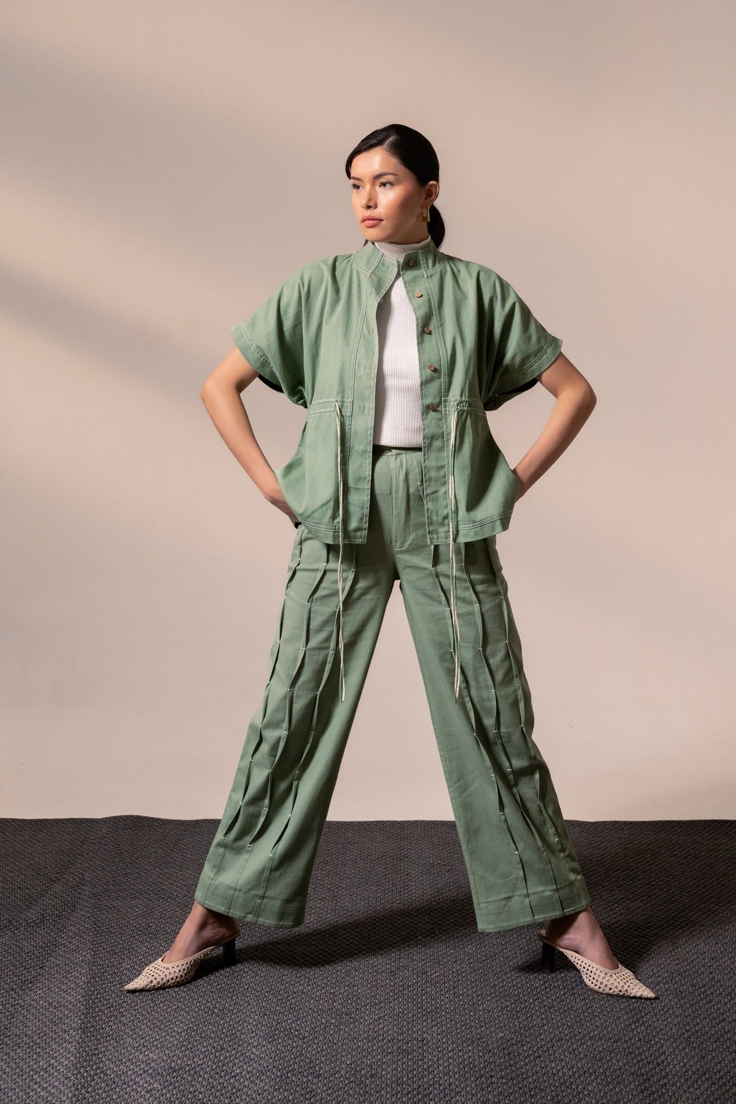 Fern green denim top by Alternative, stylish women’s blouse featuring a relaxed fit and button-front design.