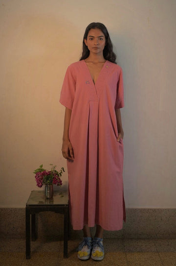 Deeta Rosa dress displayed on a hanger, showcasing its feminine design and soft pink fabric for stylish women's dresses