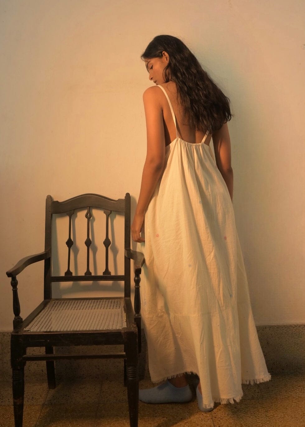 Deeta Hana slip dress featuring a silky, flowy fabric with thin shoulder straps and a relaxed fit, shown on a model.