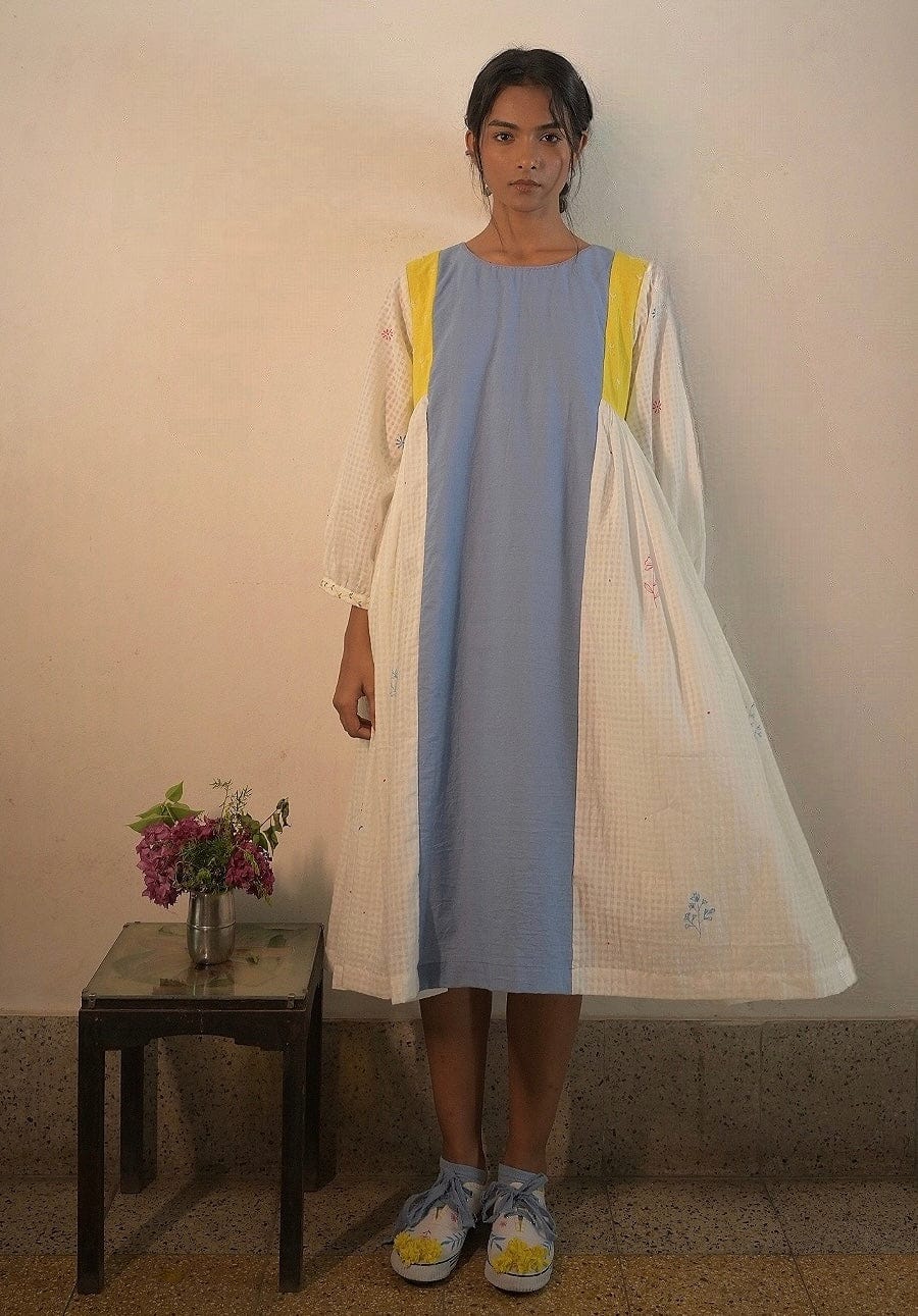 Deeta Kiku dress displayed on a hanger, featuring a stylish, elegant design with floral patterns and lightweight fabric.