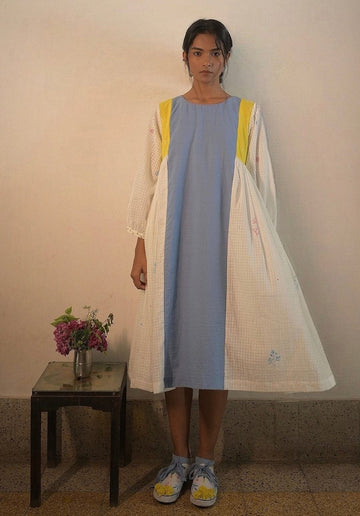 Deeta Kiku dress displayed on a hanger, featuring a stylish, elegant design with floral patterns and lightweight fabric.
