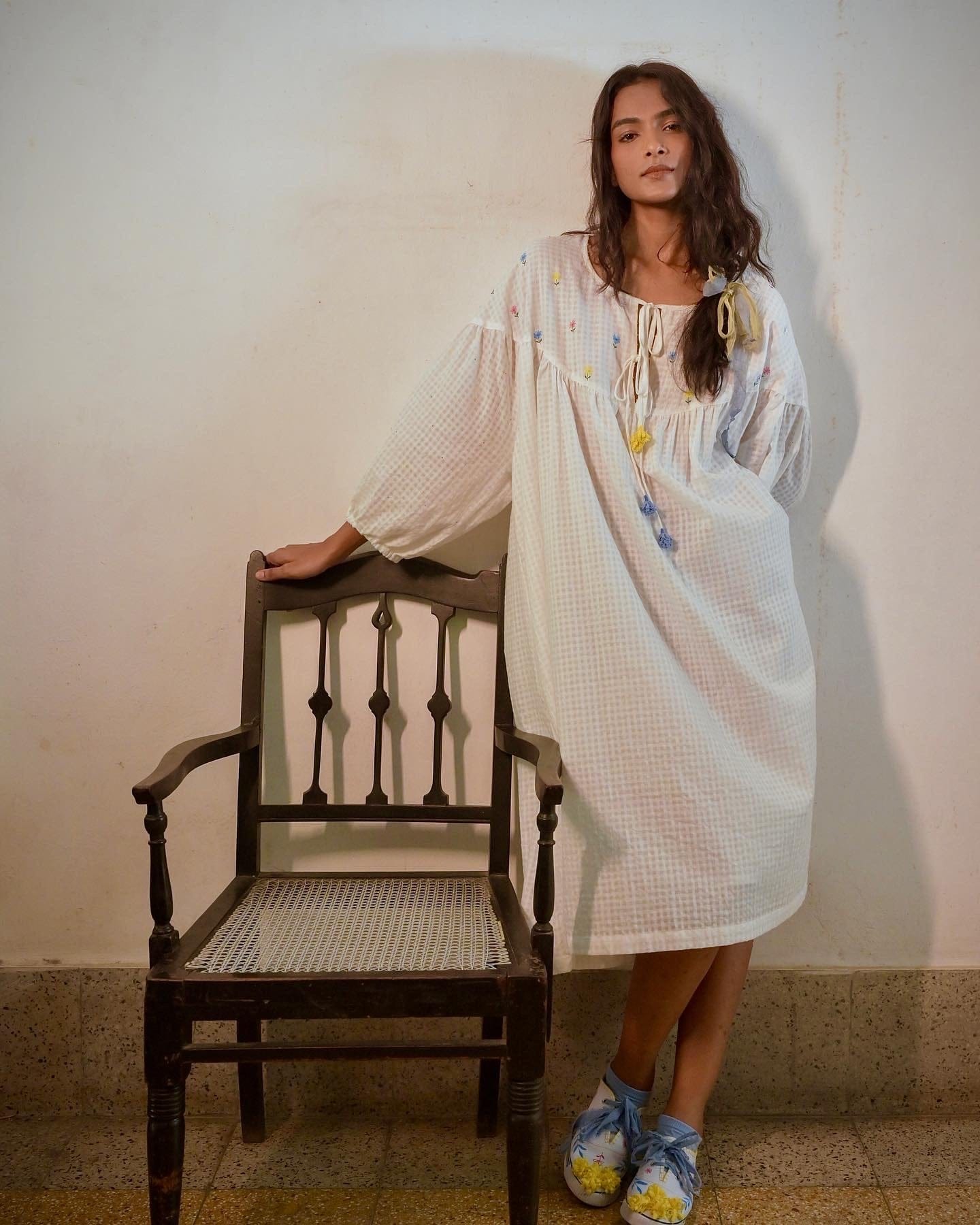 Deeta Flora oversized white dress displayed on a hanger, showcasing its flowing fabric and relaxed fit.