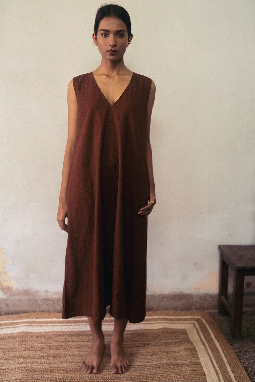 Deeta clay-colored dress featuring a stylish, flowy design with a fitted waist and elegant neckline.