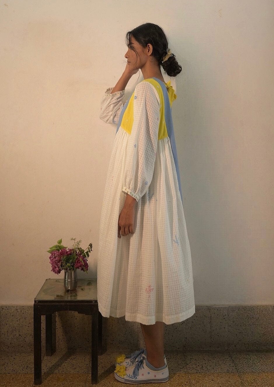 Deeta Kiku dress displayed on a hanger, showcasing its elegant design and fabric details, perfect for stylish occasions.