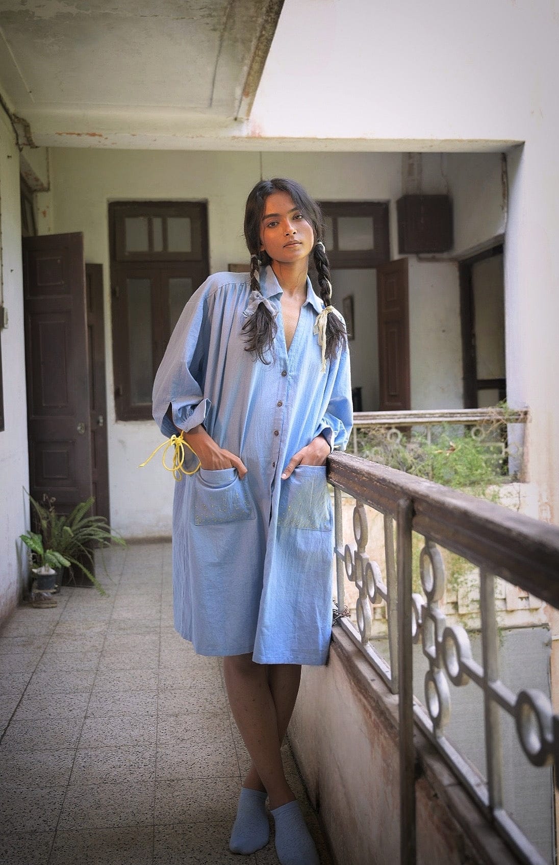 Deeta Mavi shirt dress, casual women's dress with button front and collar, in a soft blue fabric, displayed on a hanger.