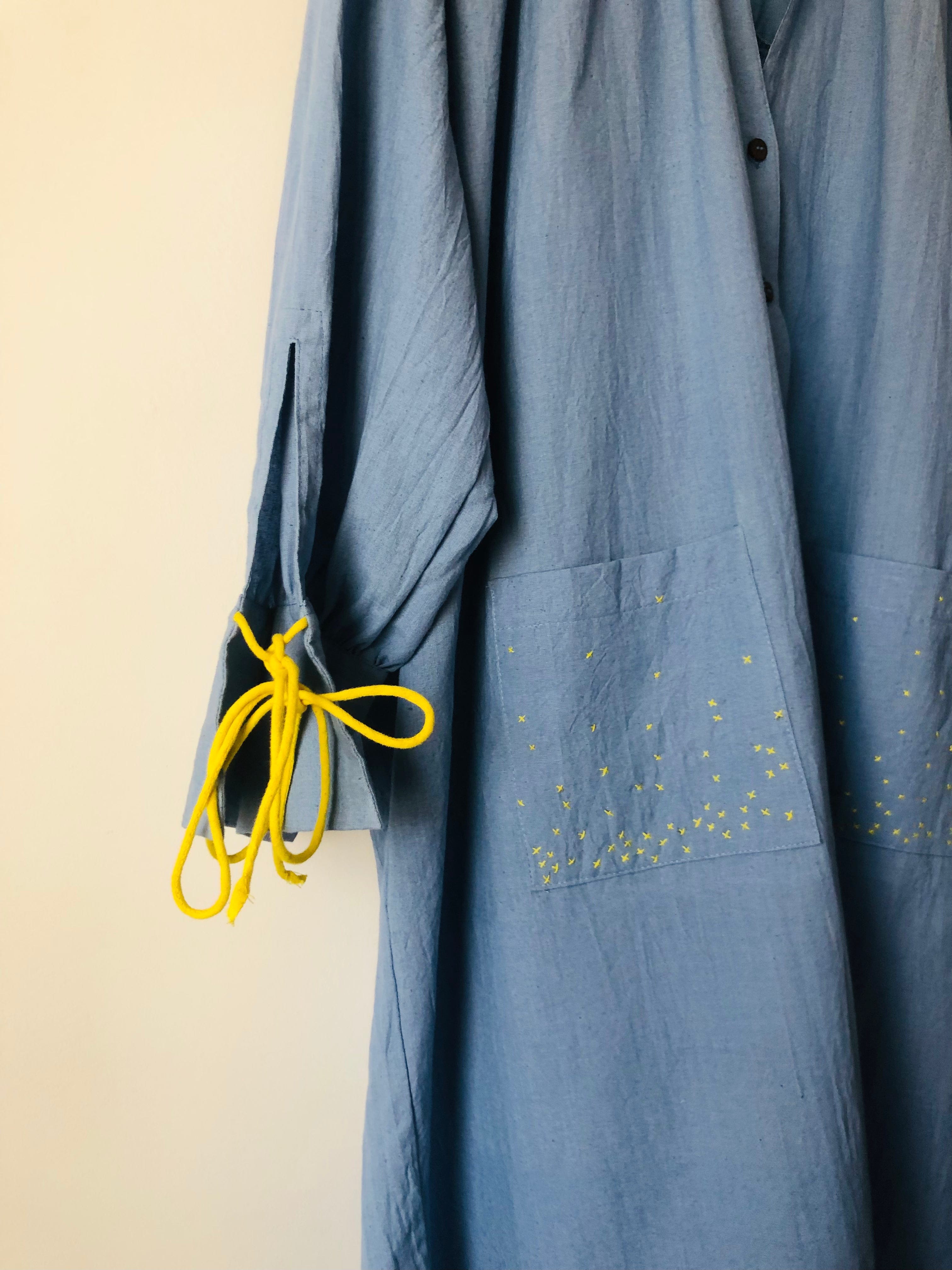 Deeta Mavi shirt dress with button-front design, collar, and long sleeves, displayed on a hanger against a plain background.