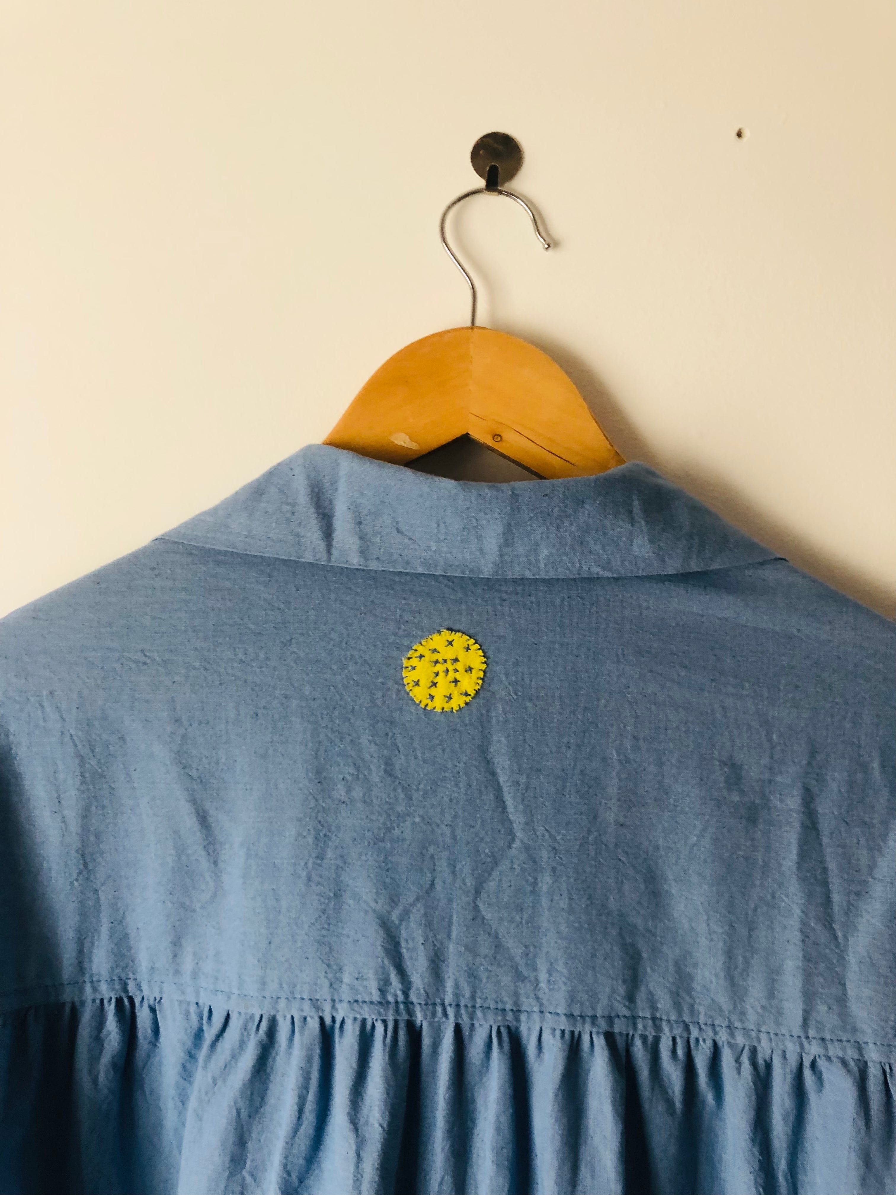 Deeta Mavi shirt dress with long sleeves, collar, and button-front design, displayed on a hanger against a neutral background.