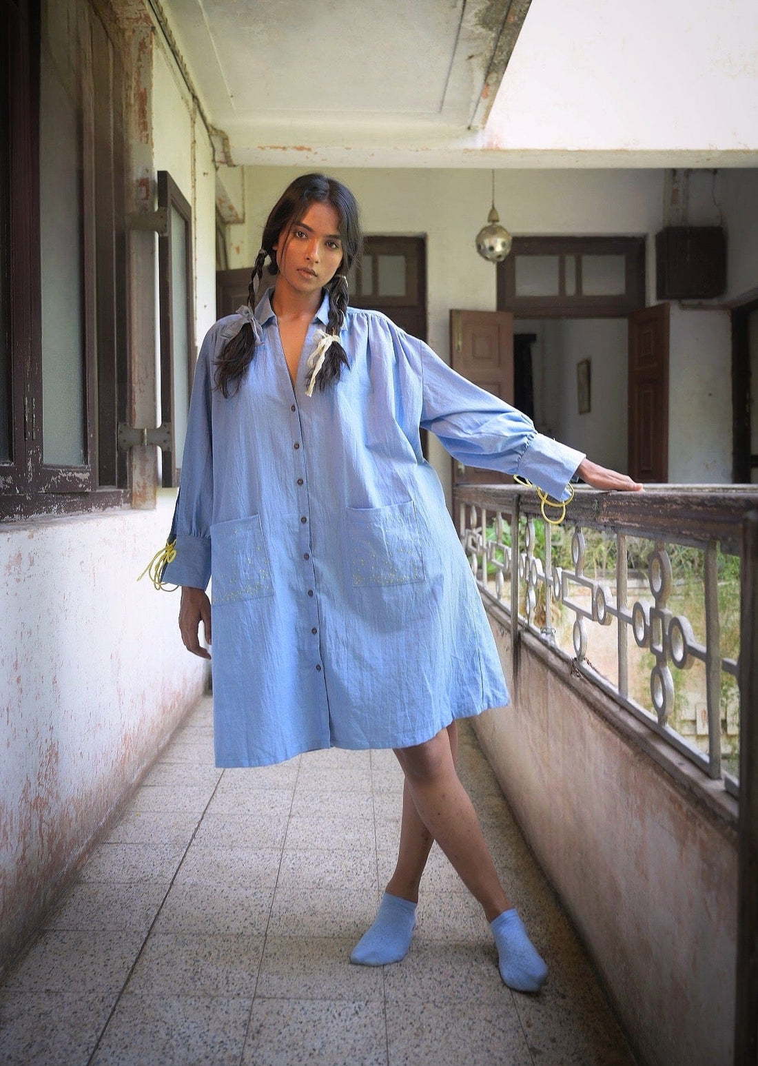 Deeta Mavi shirt dress, casual women's dress with button front and collar, in a soft blue fabric, displayed on a hanger.