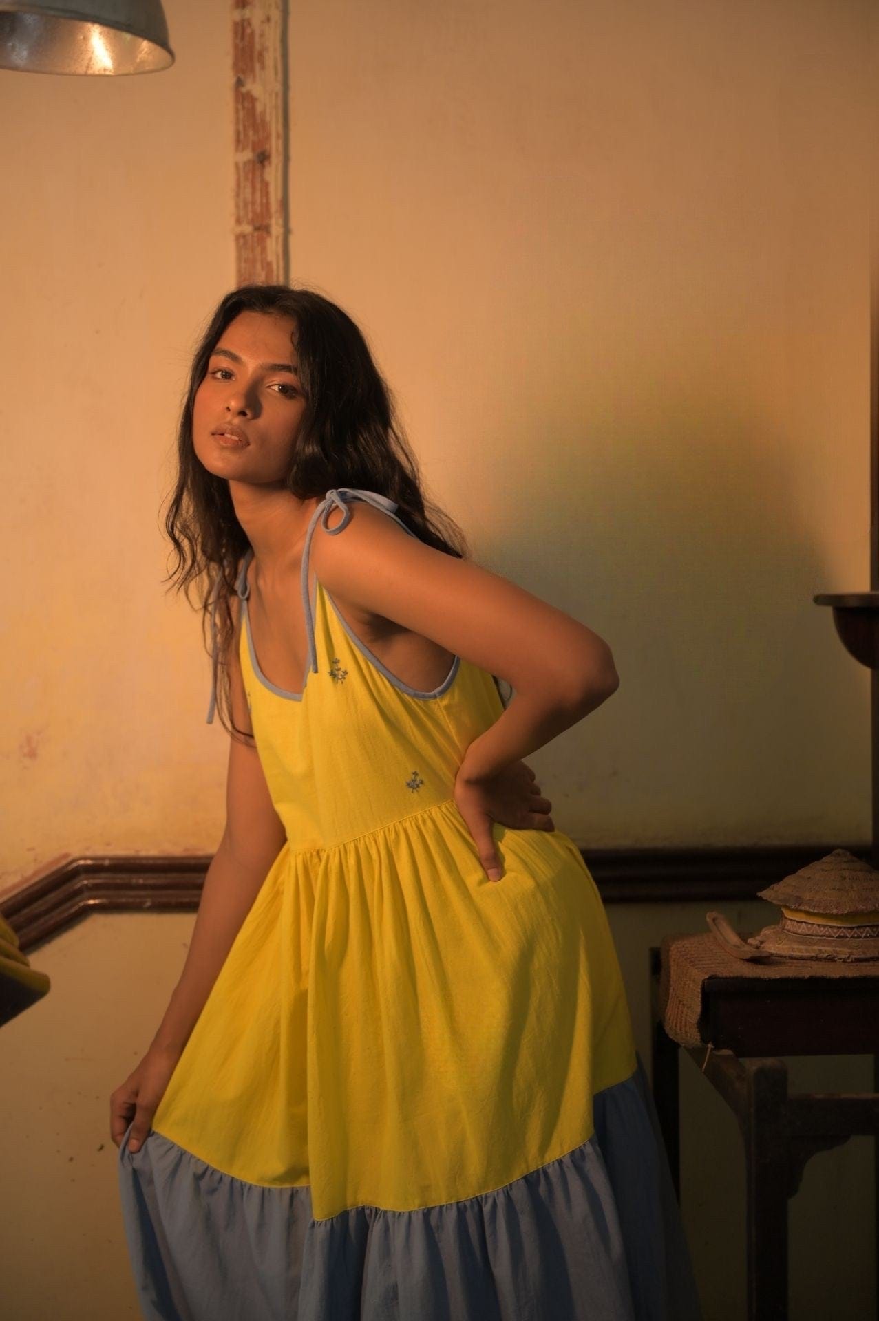 Deeta Kira slip dress featuring a sleek, minimalist design with smooth fabric and adjustable straps, shown on a hanger.