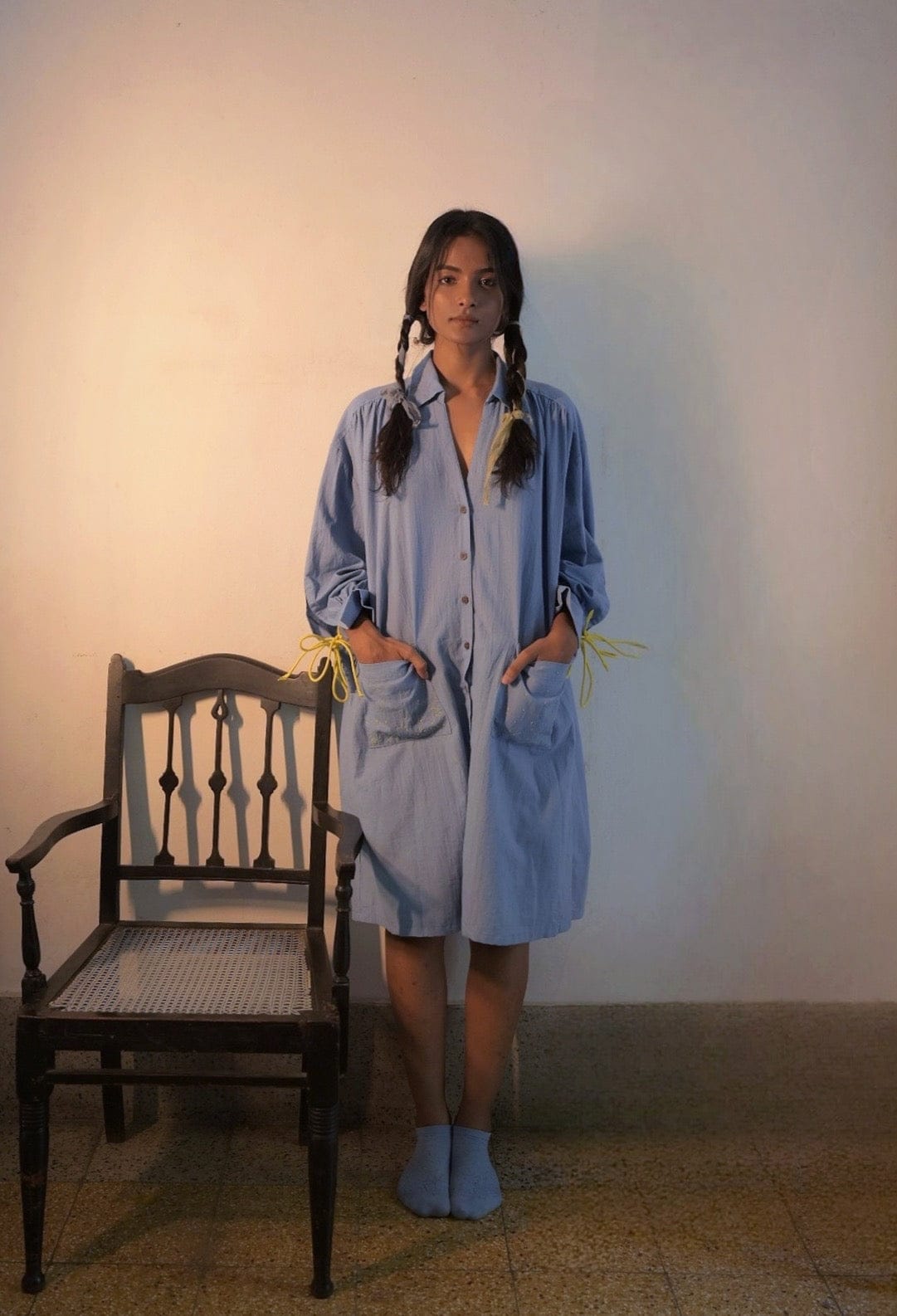 Deeta Mavi shirt dress featuring a relaxed fit, button front, and collar, styled with rolled-up sleeves on a model.