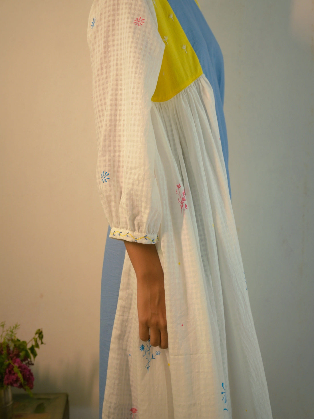 Deeta Kiku dress displayed on a hanger, featuring a stylish, elegant design with floral patterns and lightweight fabric.