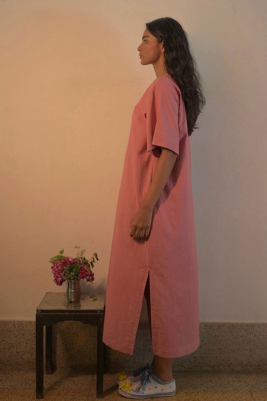 Deeta Rosa dress displayed on a hanger, showcasing its feminine design and soft pink fabric for stylish women's dresses