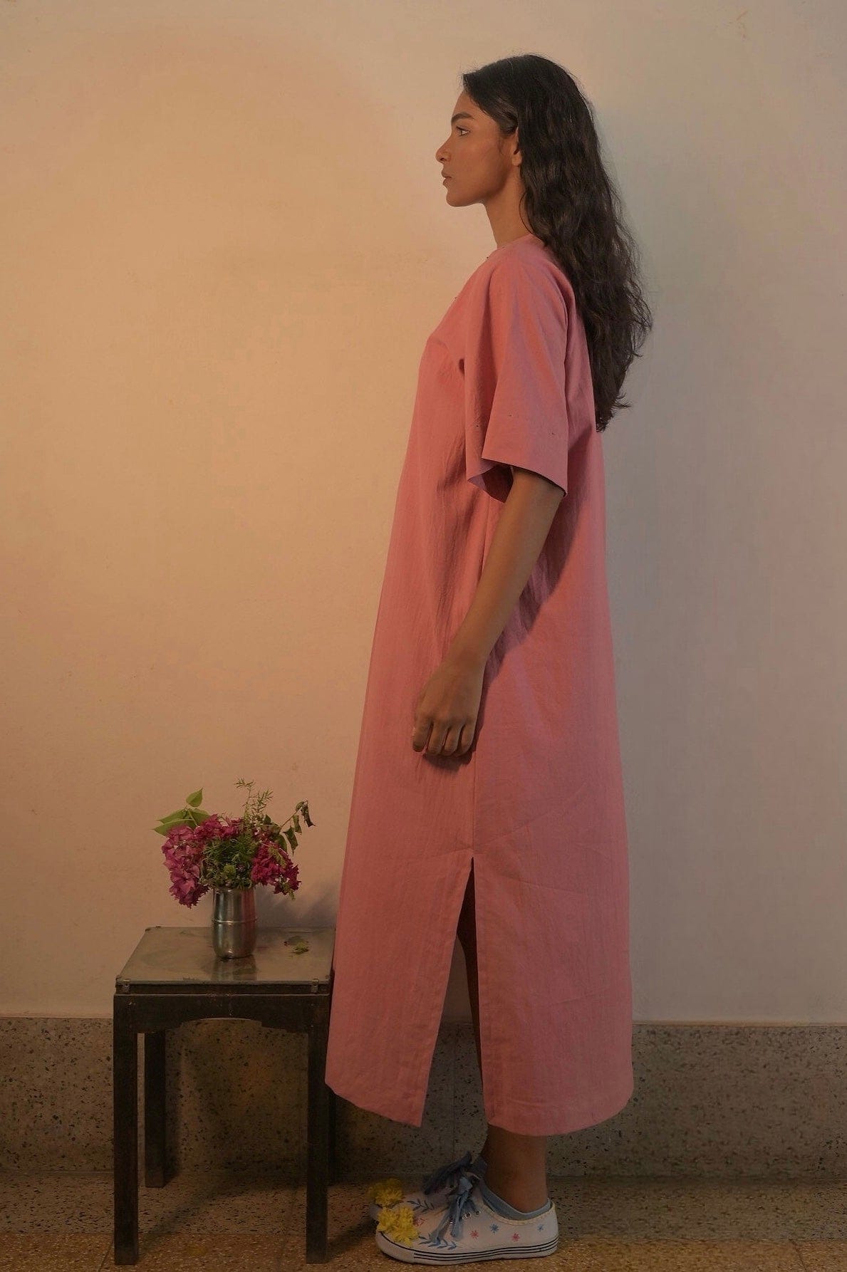 Deeta Rosa dress featuring a flowing fabric, vibrant pink color, and elegant design perfect for casual or special occasions.