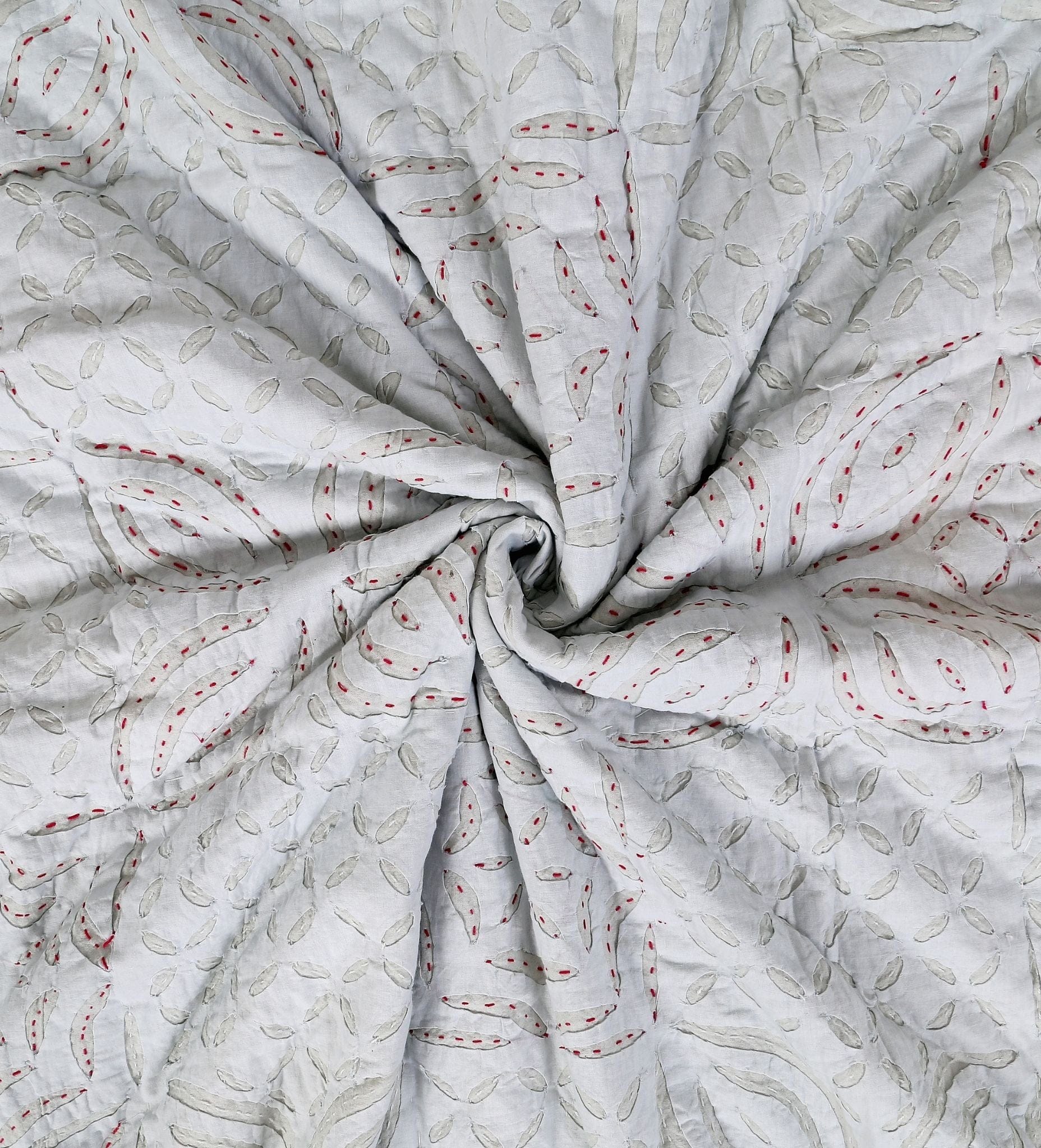 Close-up of Bombaybirds sky quilt applique in pastel blue, showing textured cotton fabric and intricate stitched details.