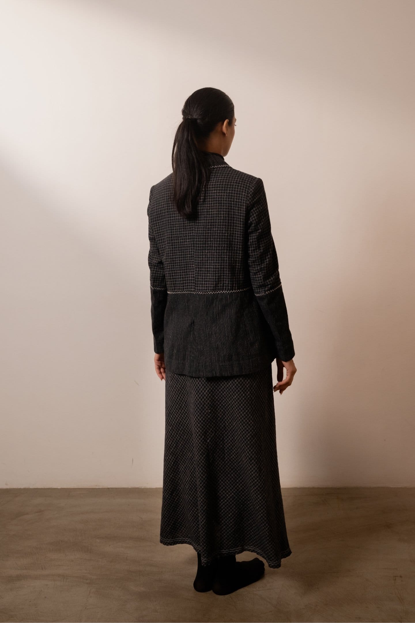 Black lava check skirt by Alternative featuring bold lava-black check patterns and a stylish, fitted design.